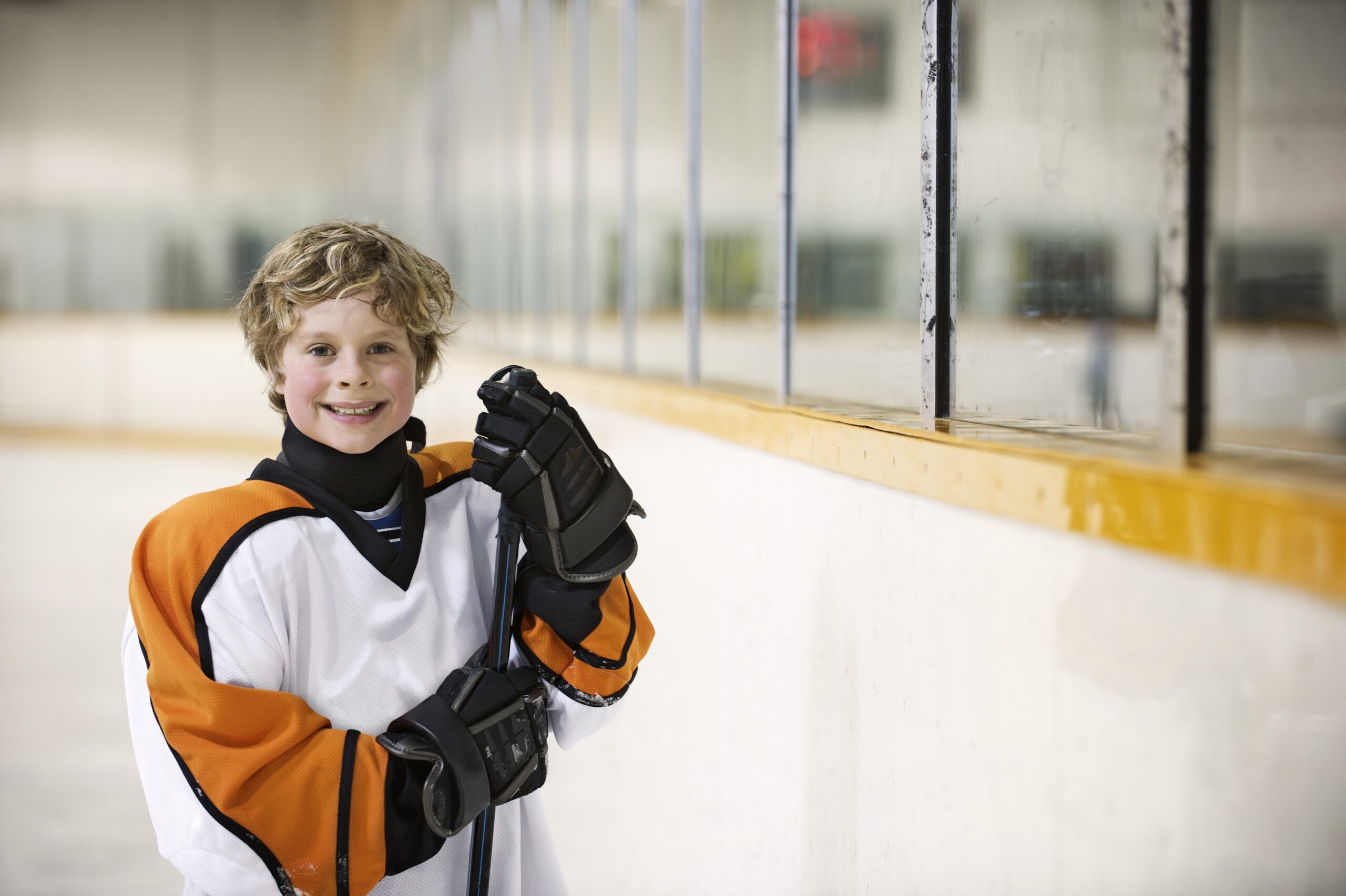 Young hockey player Standing with Stick scaled